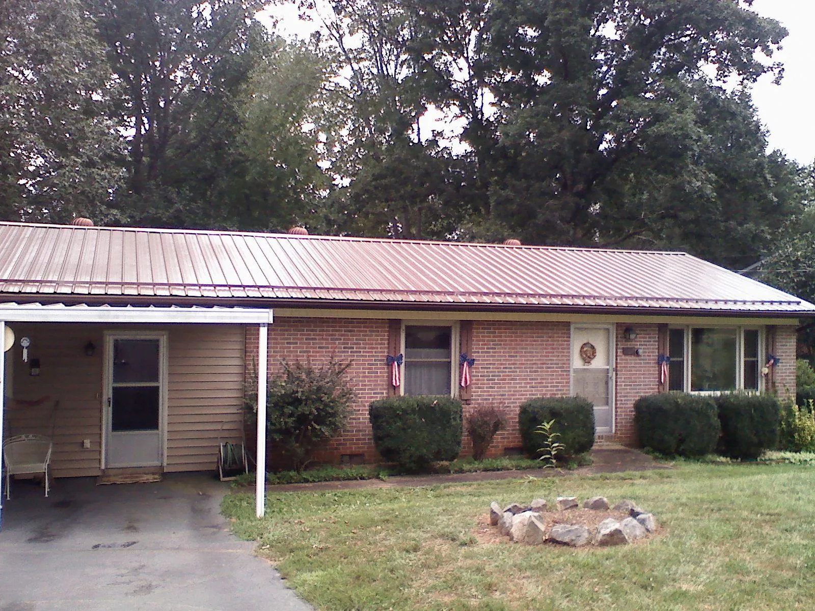 Bronze metal roof and carport on a brick ranch home — Roof Repair work by our crew in Loma Linda